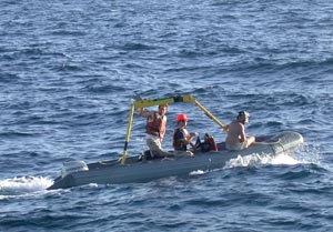  Uriel Carpenter (left), Jennifer Hickey (driving the boat) and Jerry Graham were the crew in the Zodiac for the recovery of Alvin today.