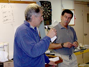  Dan Fornari (left) and Co-Chief Scientist Steve Hammond plan the strategy for the cruise&rsquo;s four remaining Alvin dives (see whiteboard behind Dan). 