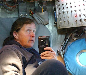  Susan Humphris reports her observations into a tape recorder as she sits in the Alvin’s “ball,” or titanium sphere.