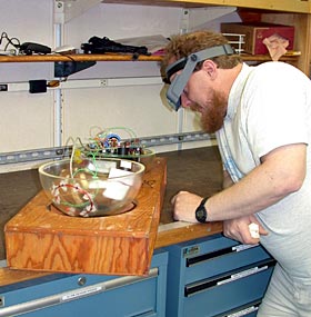  Al Duester repairs ABE&rsquo;s transponder in one of Atlantis&rsquo; labs. &ldquo;He&rsquo;ll gripe about having to fix it, but he really loves it,&rdquo; said Dana Yoerger with a smile. &ldquo;He&rsquo;s a nerd warrior going into battle, slaying dragons with his soldering gun.&rdquo;
