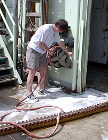 Graduate student Rhian Waller gets up to her ankles in soap suds helping scrub out Alvin&rsquo;s hangar.