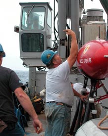 Wayne Bailey, Atlantis&rsquo; bosun, helps guide the crane that moves ABE and helps secure it on deck. That&rsquo;s Raul Martinez, ordinary seaman, operating the crane. While the ship&rsquo;s crew were hard at work getting us through the initial stages of our journey, most of the scientific crew were below deck cuddling up with a variety of seasickness medications and taking it easy. 