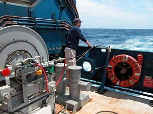 Scientist Dave Shuster watches the line that drags Maggie two boatlengths behind the ship. Maggie is the informal name for the device the science team uses to gain information about the area&rsquo;s magnetic fields. 