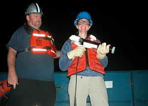 Shipboard Scientific Services Group Technician Dave Sims and scientist Selene Eltgroth shoot the XBT, or expendable bathythermograph, into the dark of last night&rsquo;s ocean. The XBT has a temperature sensor attached to a 760-meter wire that sends the information back to R/V Atlantis.