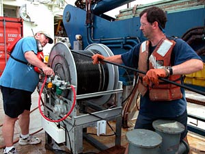 Shipboard Scientific Services Group Technicians Dave Sims, left, and Dave Dubois, reeling in Maggie, the magnetometer that gives us information about magnetic fields. We had to have this device back on board before launching the transponders (see image 4).