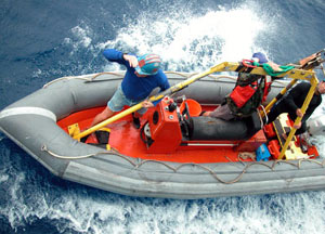 The Avon is launched from the Atlantis to go out to Alvin for its recovery. From left to right, Alvin Technician and Pilot-in-training Mark Spear, Able Seaman Jerry Graham, and Ordinary Seaman Raul Martinez in the Avon. 