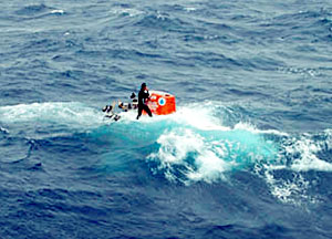 The swells were increasing in height and force throughout the recovery. Ordinary Seaman Raul Martinez rides the sub back to the ship while maintaining radio communication with Alvin's pilot and the ship's bridge. 