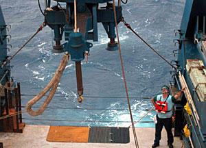 Third Assistant Engineer Richard Boyd watches from the deck during a maintenance check on the "A-frame." 