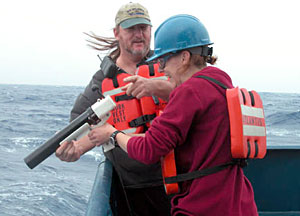 Scientist Laura Robinson and SSSG Technician Dave Sims get whipped by the wind as Robinson shoots the Expendable Bathy Thermograph, or XBT, into the water. The XBT takes a temperature profile of the ocean.  