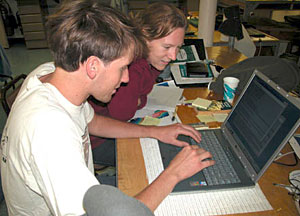 Scientists Laura Robinson and Alex Gagnon hard at work "scripting," or programming, a suite of options for which path the ship should take for future SeaBeam operations. The choice of which path to take will depend on whether the weather continues to deteriorate.  