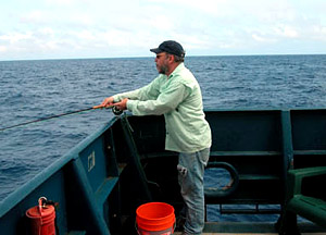ABE maestro, Dana Yoerger, fly casting off the stern of Atlantis. Many crew members pass some of their time fishing. Although Yoerger was unsuccessful this time around, few cruises end without several nice catches. 