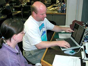 Biologists Tim Shank and Rhian Waller review data about a recent collection of animals. 