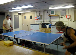 The ping-pong tournament is heating up. Here Wayne Bailey, left, the ship's bosun, and Tim Logan, communications manager, go at it. "Lucky" Logan advanced to the quarterfinals. Captain Gary Chiljean is the perennial man to beat. 