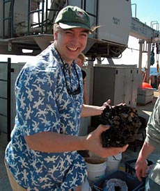 Chief Scientist Jess Adkins holds the prize catch of the day, and perhaps of the cruise: the largest single Desmophyllum cristagalli coral he&rsquo;s ever seen.  