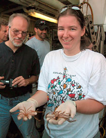 Biologist Kate Buckman holds two crematulids, otherwise known as stalkless crinoids, after mining the collection basket from today's Alvin dive. Fellow biologist Jon Moore looks on, with sub pilot Bruce Strickrott in the background. 