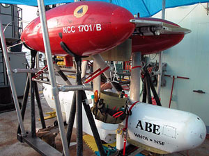 ABE, the autonomous benthic explorer, in its customary resting position, a scaffold on the starboard deck of the ship. The Bucket Boss hanging from the frame is ABE's constant on-shore companion, since the team of engineers in charge of the deep-sea robot are often tweaking its innards for maximum performance. 