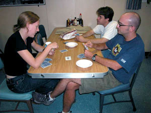 Cards are a favorite pastime when you can't get outside. Here scientists Jeff Mendez, in back, Dave Shuster and Laura Robinson play a game of euchre in the mess deck. 