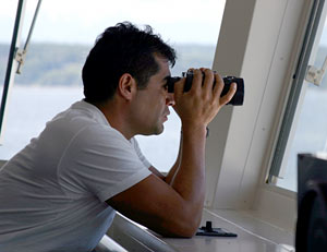 Seaman Raul Martinez keeps watch from the bridge, a top area of the ship where the captain and mates steer and direct the vessel’s position.