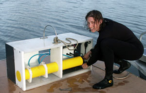  Graduate student Alison LaBonte in San Diego&rsquo;s Mission Bay with the flow meter she designed and nicknamed the Big Banana for its long, yellow pressure case.