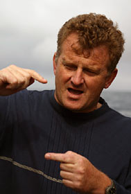  Back on the ship after the dive, Marine Geologist Kevin Brown from the Scripps Institution of Oceanography describes the depth of a layer of sediment he saw on the Main Endeavour vent field.