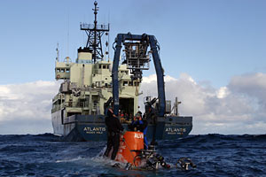 Seaman Raul Martinez keeps watch from the bridge, a top area of the ship where the captain and mates steer and direct the vessel&rsquo;s position.