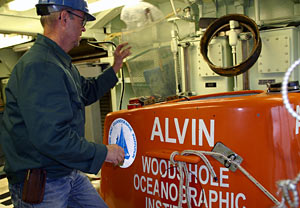 Electrical Technician George Meier with the Alvin group checks that the sub&rsquo;s sail lid is working properly. During a dive, the lid keeps rocks that may fall from tall undersea chimneys from banging into the hatch. 