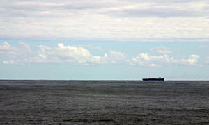A container ship passes 10 miles (16 kilometers) northeast of Atlantis. We have seen or communicated with other ships nearly every day, but this one provided a closer glimpse. 