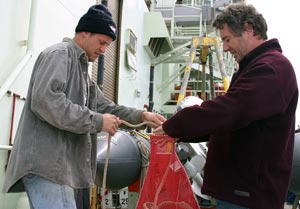Gavin Eppard (left) and Pat Hickey, both with the Alvin group, tidy lines for storage until the next expedition.