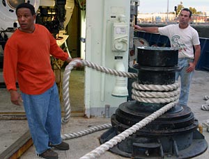 As we waited in the Ballard locks, Jose Andrande (left) and Jack Greenberg, both seamen on Atlantis, helped stabilize the ship with hawsers. Alvin is visible behind in its hangar. 