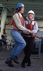 Graduate students Alison LaBonte (left) and Kris Ludwig break into a spontaneous swing dance on the ship&rsquo;s deck. Chief Scientist Deb Kelley remarked later that she was glad to see this kind of excitement among young people doing oceanography.  