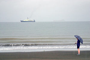 The morning before departing, biologist Rhian Waller checks out the location of our vessel Atlantis, anchored about a half mile offshore Puntarenas. 