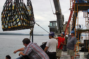 The ship�s crew uses a crane to lift supplies on to the deck. In Puntarenas we purchased about 4,000 pounds of ice, fresh fish, vegetables, and fruit, including more than a dozen boxes of Costa Rican bananas. �We�ll probably use all of this during our 16 days at sea,� ship steward Carl Wood said.  (Photo by Amy Nevala)