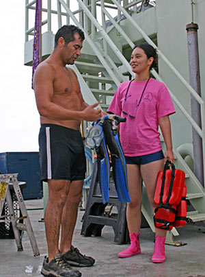 Shipboard technician Kazumi Baba asks Raul Martinez about his experiences as a swimmer certified to help launch and recover Alvin. Kazumi started her swim training today, a responsibility that requires good communication skills and strong swimming abilities. 