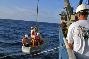 Crew launches the small boat for Alvin�s recovery. The boat takes swimmers to Alvin as it surfaces, where they attach a towline and bring the sub to the ship. (Photo by Amy Nevala)