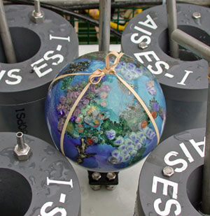 Today Alvin carried a glass �planet� made by artist Josh Simpson in Shelburne Falls, Massachusetts.  Geologist Dan Fornari is a friend of the artist, and has placed these grapefruit-size balls at hydrothermal vents in the Pacific, Atlantic, and Indian Oceans. Josh said he thinks of the balls as artifacts that could be left for future generations to find. (Photo by Dan Fornari)