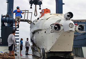 Bruce Strickrott, supervising today�s launch, positions the catwalk for loading people inside Alvin. The submersible is 23 feet (7 meters) long, but its 6-foot (2-meter) diameter sphere is large enough for only the pilot and two passengers.