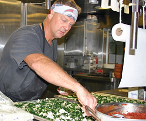 Pizza night comes half way through the expedition. �It�s the meal most asked for by scientists,� said steward Carl Wood as he prepares garlic, spinach, and blue cheese pizzas. He baked eight pizzas for all 53 people on board Atlantis. (Photo by Amy Nevala)