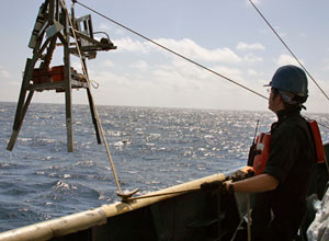 Bruce Strickrott, supervising today�s launch, positions the catwalk for loading people inside Alvin. The submersible is 23 feet (7 meters) long, but its 6-foot (2-meter) diameter sphere is large enough for only the pilot and two passengers.