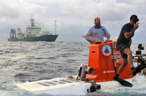 Bruce Strickrott jumps from Alvin after securing safety lines that keep the sampling basket attached to the sub. Ken Feldman remains on the submersible to take care of final safety checks with the pilot. Both returned to Atlantis in the recovery boat. (Photo by Amy Nevala)