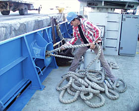 The Captain calls, “Cast off the lines!” and the ship is free of the dock and heading out to sea. Jeff Benitz pulls in one of the docking lines.
