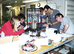Scientists in the lab prepare the Sipper Sampler for the first dive. Scientists will use the Sipper Sampler “sip” fluids from tiny spaces around the hydrothermal vents.