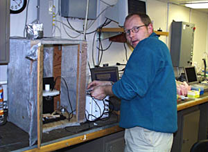 The submarine Alvin sits in its hanger onboard R/V Atlantis. The boxing gloves on Alvinâs manipulator protect people who are loading the basket from bumping their heads.