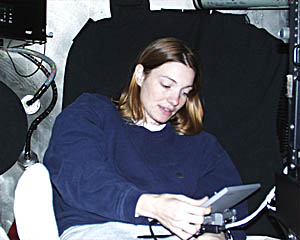 Liz McCliment sits inside Alvin and checks her computer as they descend to the seafloor. Because the inside of Alvin is only two meters (about six feet) in diameter, it is hard to take a photo without other people’s feet getting in the picture! That’s Craig’s foot in the bottom left corner.