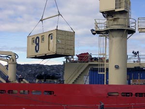 The research team�s dive van, a room-sized container with doors, swings in the air above the Gould�s deck. (Photo by L. Madin) 