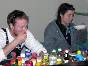 Jeff Mercer and Jamee Johnson come in from the cold aft deck after towing a plankton net and find dinner waiting for them.