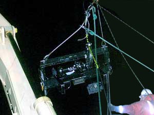 By about 11 p.m., the crane has lifted the black metal net frame above the ship’s rail, and it can be eased on board.  Success!