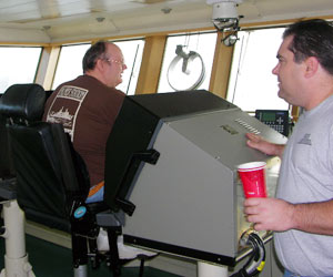 Chief Mate Kevin LeBouef, right, comes off watch as Third Mate Larry Brissette comes on watch to control the ship. (Photo by Kate Madin, WHOI)