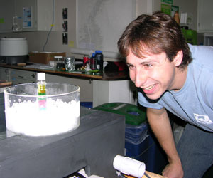 The density experiment is completed and Brennan can see how dense the pellets are by seeing which layer they have settled to.