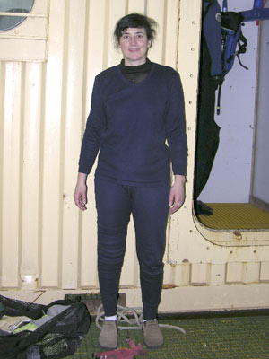 Diane DiMassa is diving with the team for the first time, and they will be in water that is at about 2 degrees C (34 degrees F). For cold-water diving, she has to put on many layers. Standing by the team�s dive van in the Gould�s hold, she starts with thick long underwear (navy) over thin long underwear (black).