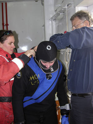 Diane needs help from Kerri� Scolardi (left) and Sandy Williams to pull on the outer �ice cap� dry hood over the inner one. 